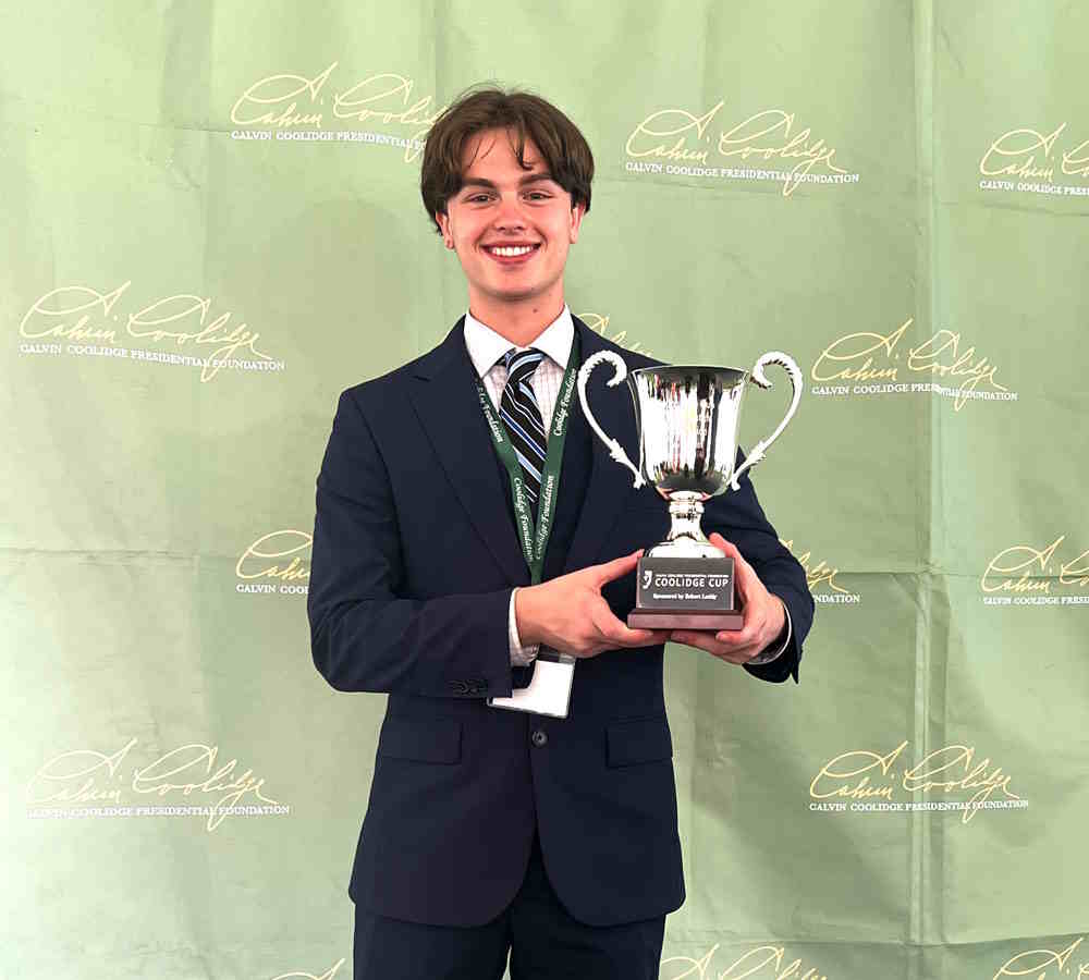 student with debate trophy