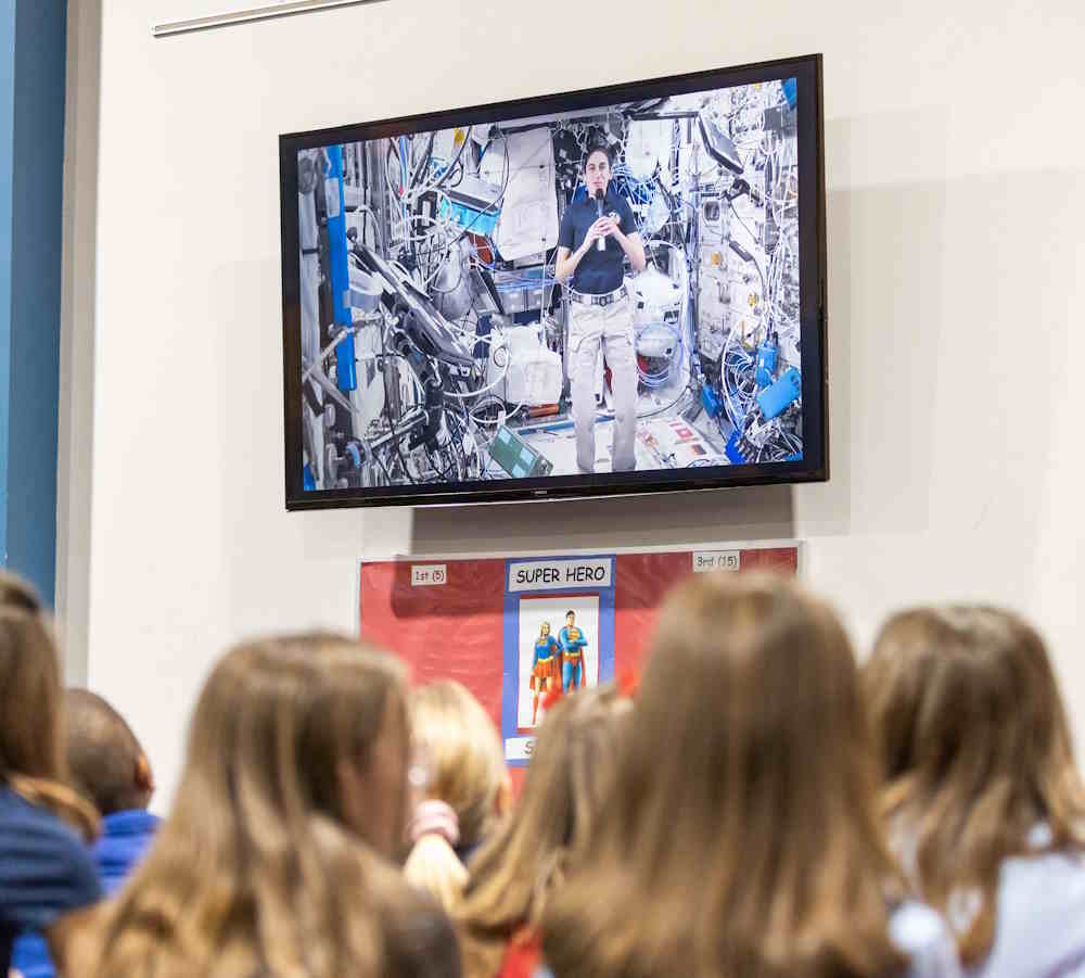 kids watching NASA astronaut on TV